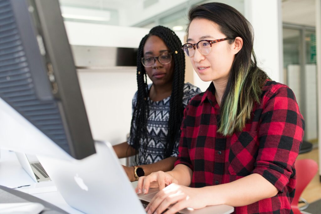 Two women looking at a computer