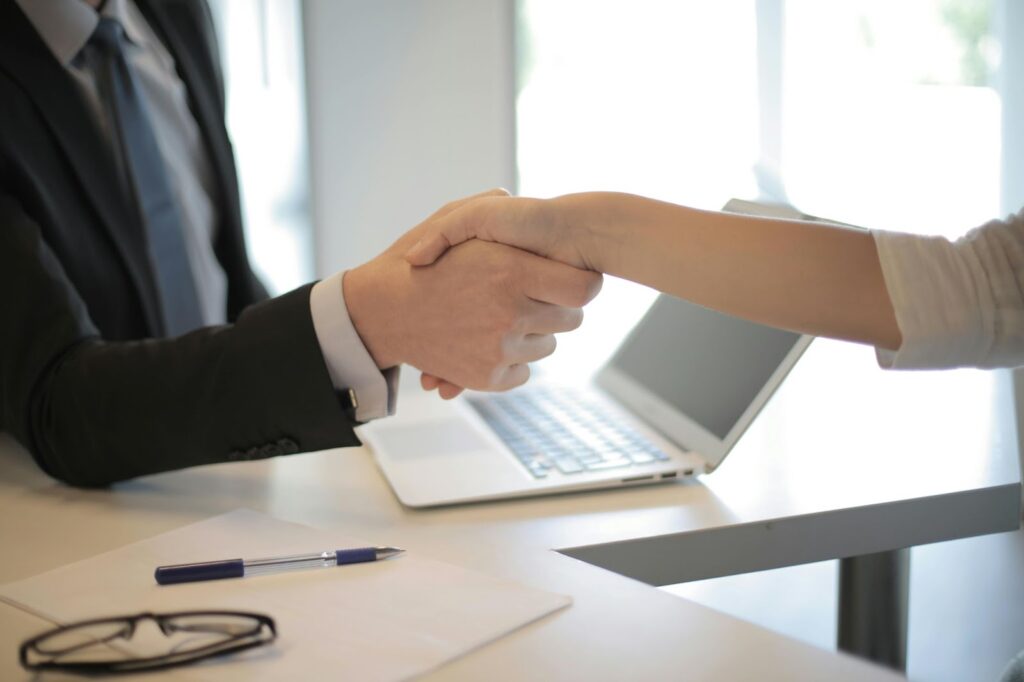 Two office workers shaking hands